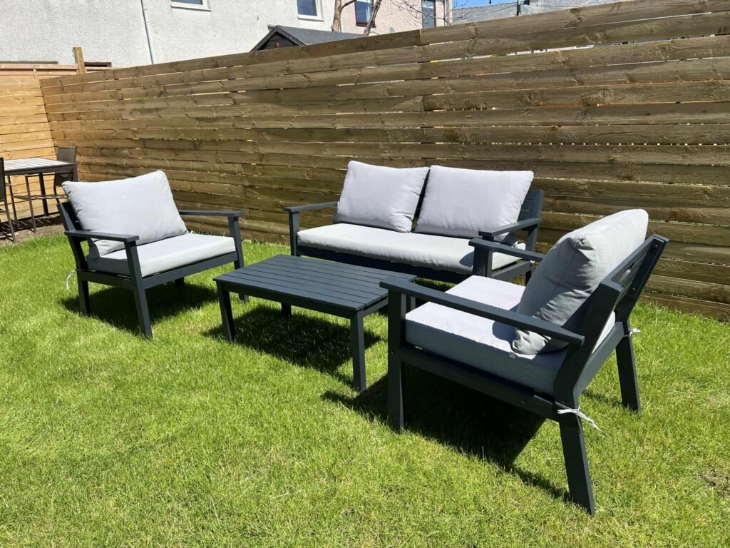 Assembled outdoor furniture set on grass.