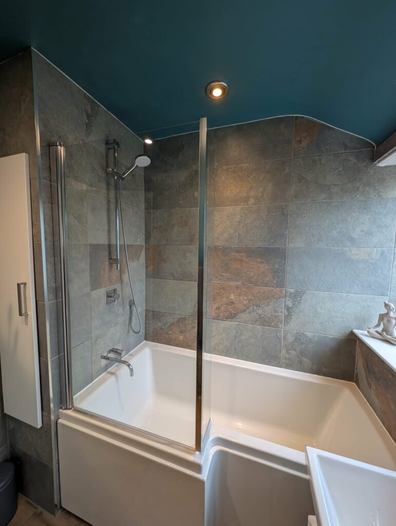 Freshly resealed bathtub with new silicone applied around edges.